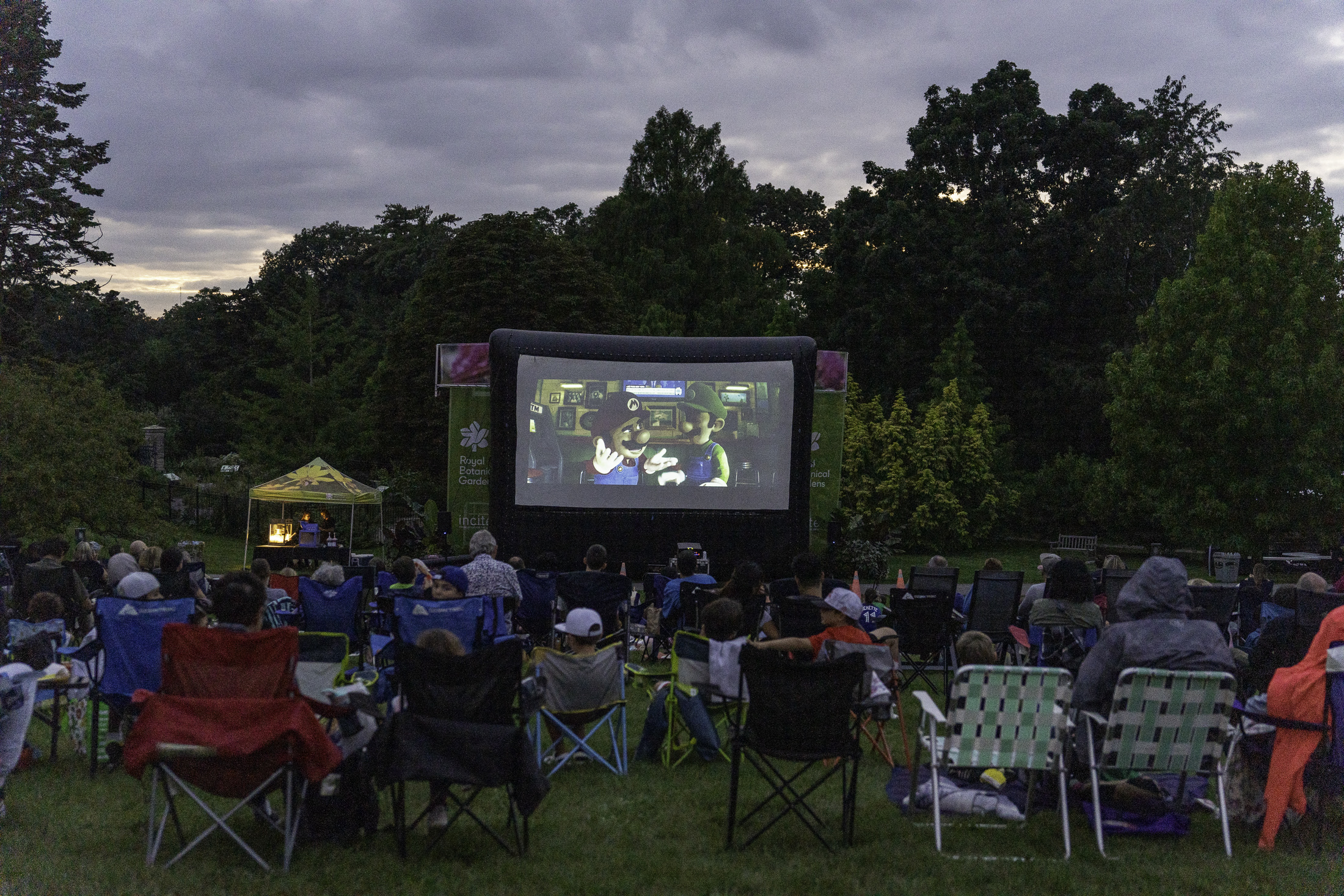 Outdoor movie event in Hendrie Park with visitors in camping chairs